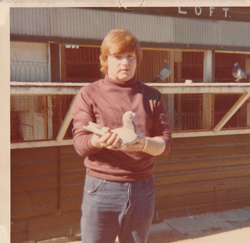 Joe Murphy holding his Palamos pigeon on return from Race 1026 milesjpg
