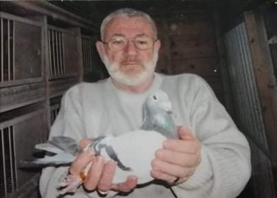 The late Michael O Connell proudly holding the blue cock which he timed in from St. Malo in France